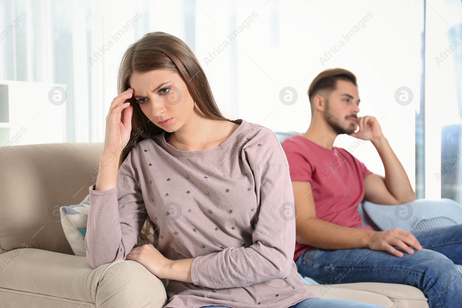 Photo of Young couple with relationship problems in living room