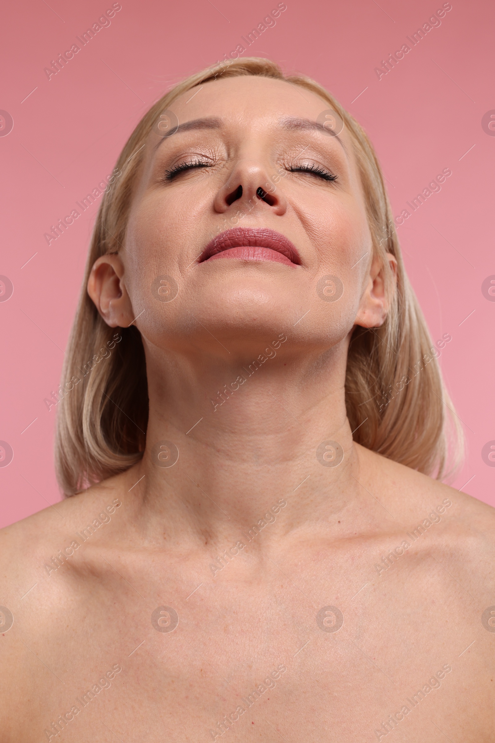 Photo of Beautiful woman with healthy skin on pink background