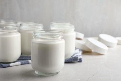 Tasty yogurt on light grey marble table