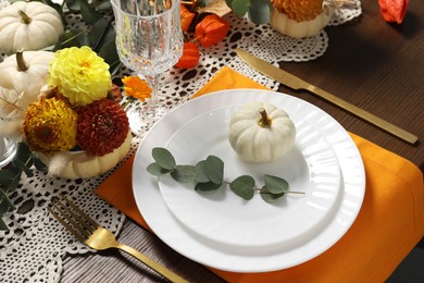 Photo of Beautiful autumn table setting. Plates, cutlery, glasses and floral decor