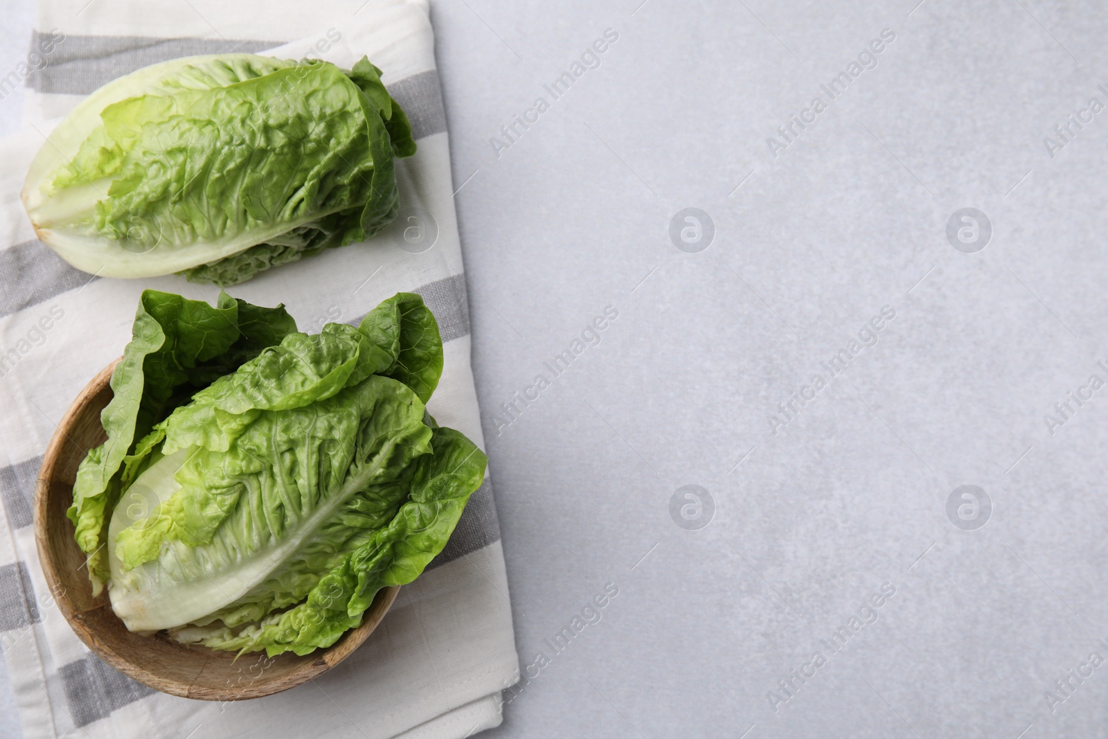 Photo of Fresh green romaine lettuces on grey table, flat lay. Space for text