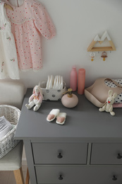 Stylish chest of drawers and accessories in child room