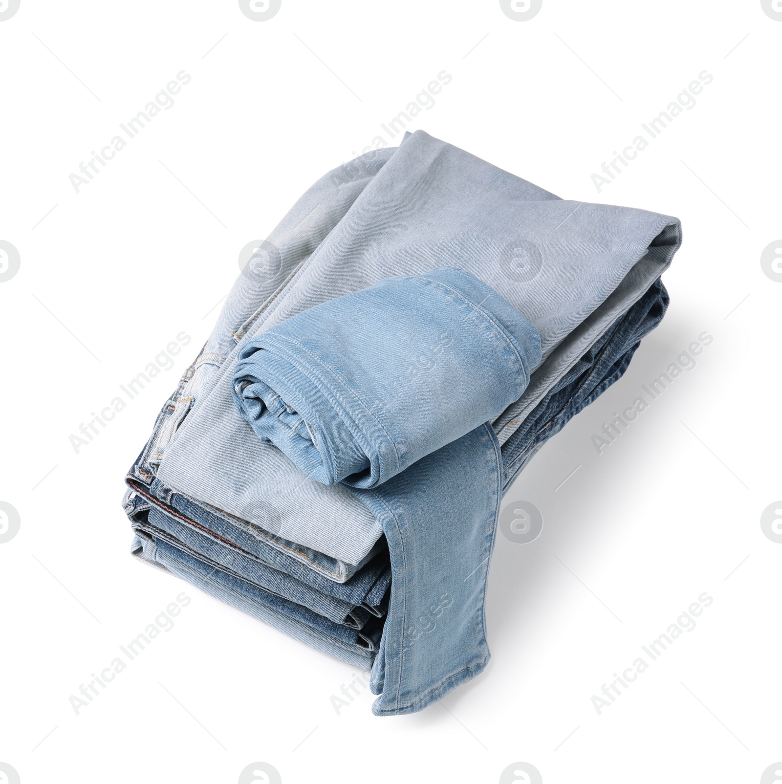 Image of Stack of different folded jeans isolated on white