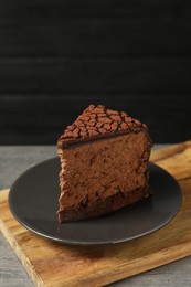 Piece of delicious chocolate truffle cake on table