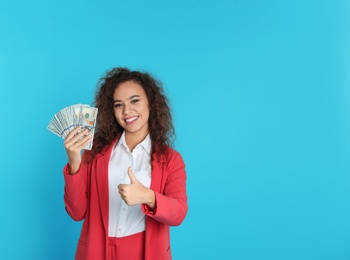 Photo of African-American businesswoman with money on color background. Space for text
