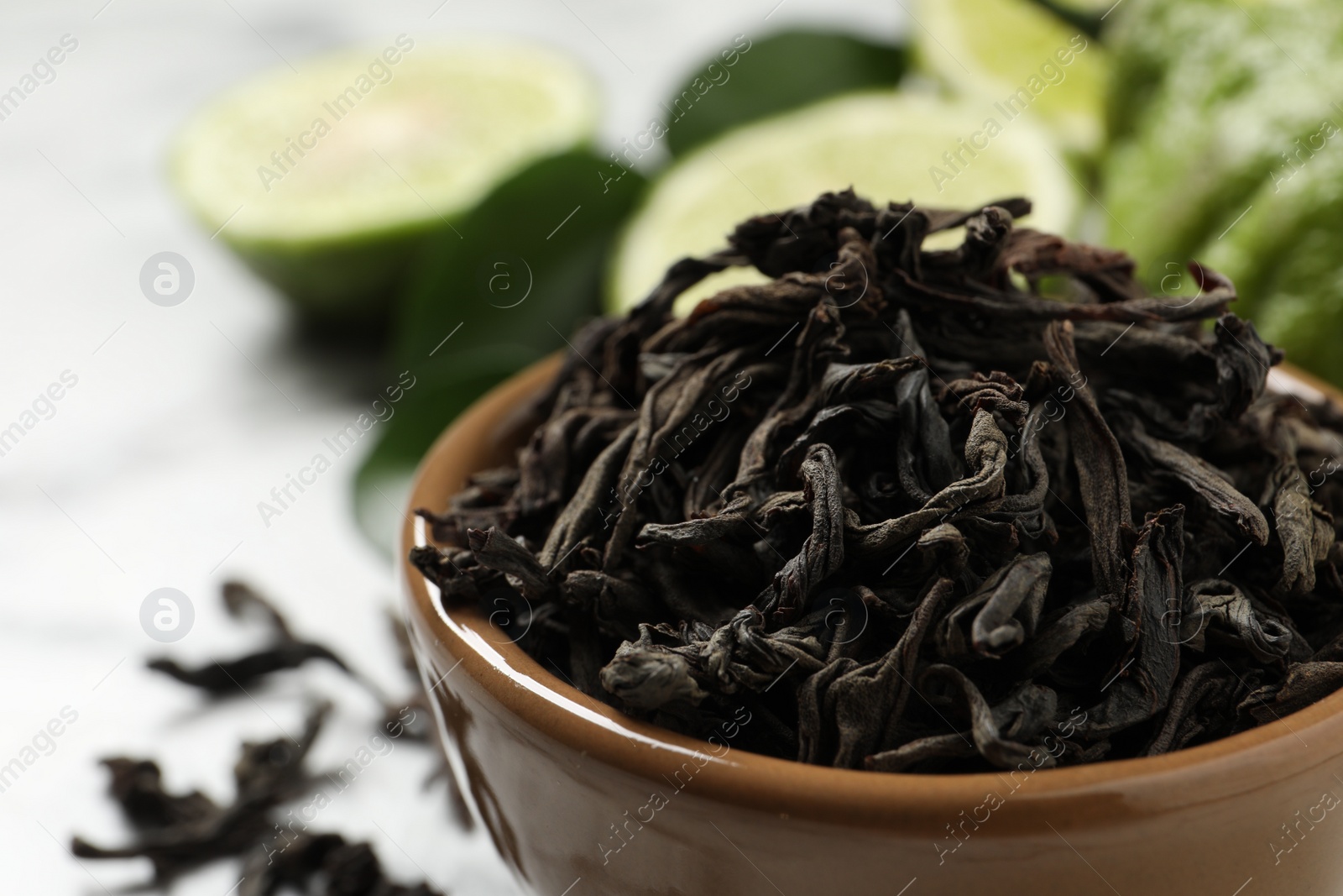 Photo of Dry bergamot tea leaves in bowl, closeup. Space for text