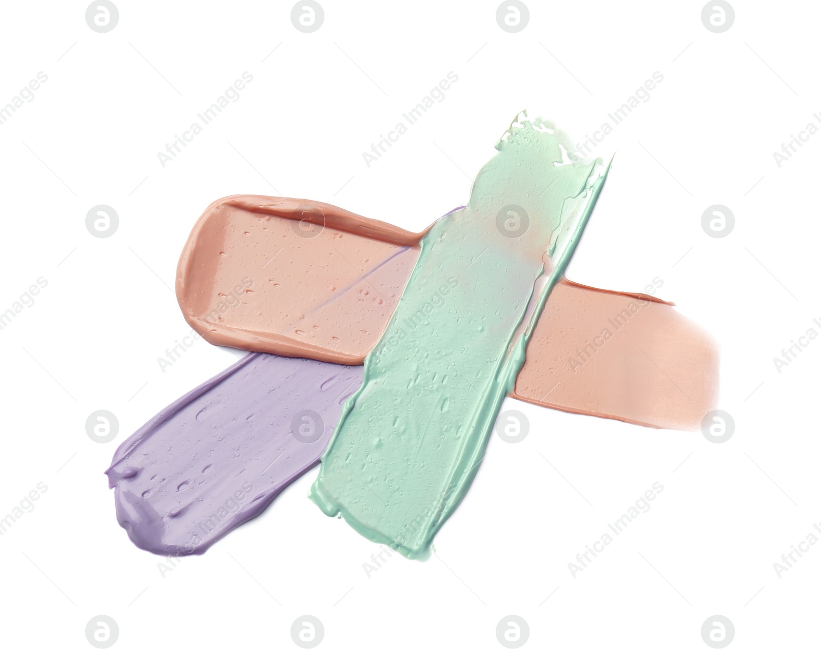 Photo of Strokes of pink, green and purple color correcting concealers on white background, top view