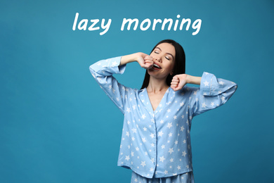 Beautiful Asian woman in pajamas stretching on blue background. Lazy morning