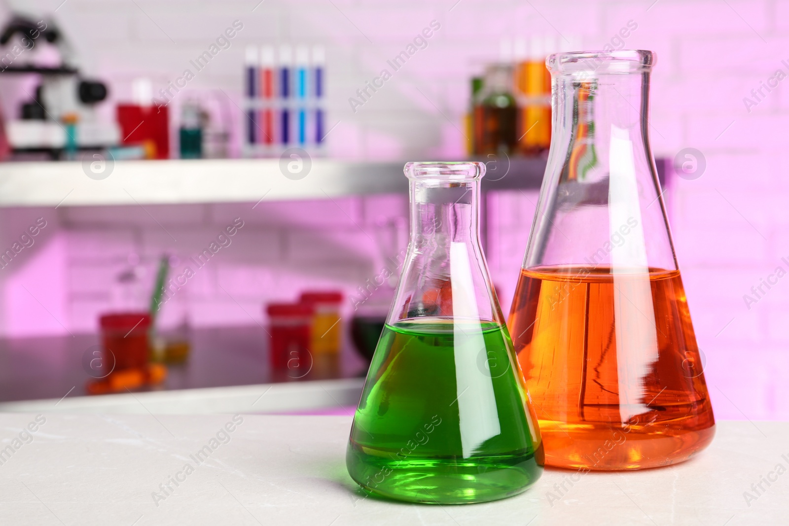 Photo of Flasks with samples on table in chemistry laboratory. Space for text