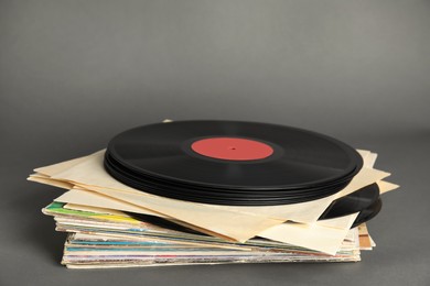 Stack of vintage vinyl records on grey background