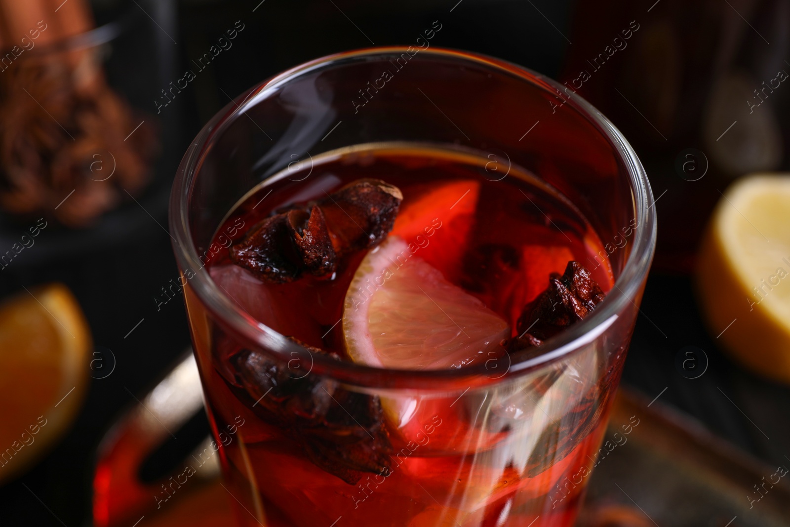 Photo of Glass of aromatic punch drink on table, closeup