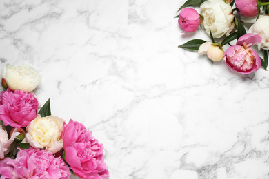 Photo of Beautiful peonies on white marble background, flat lay. Space for text