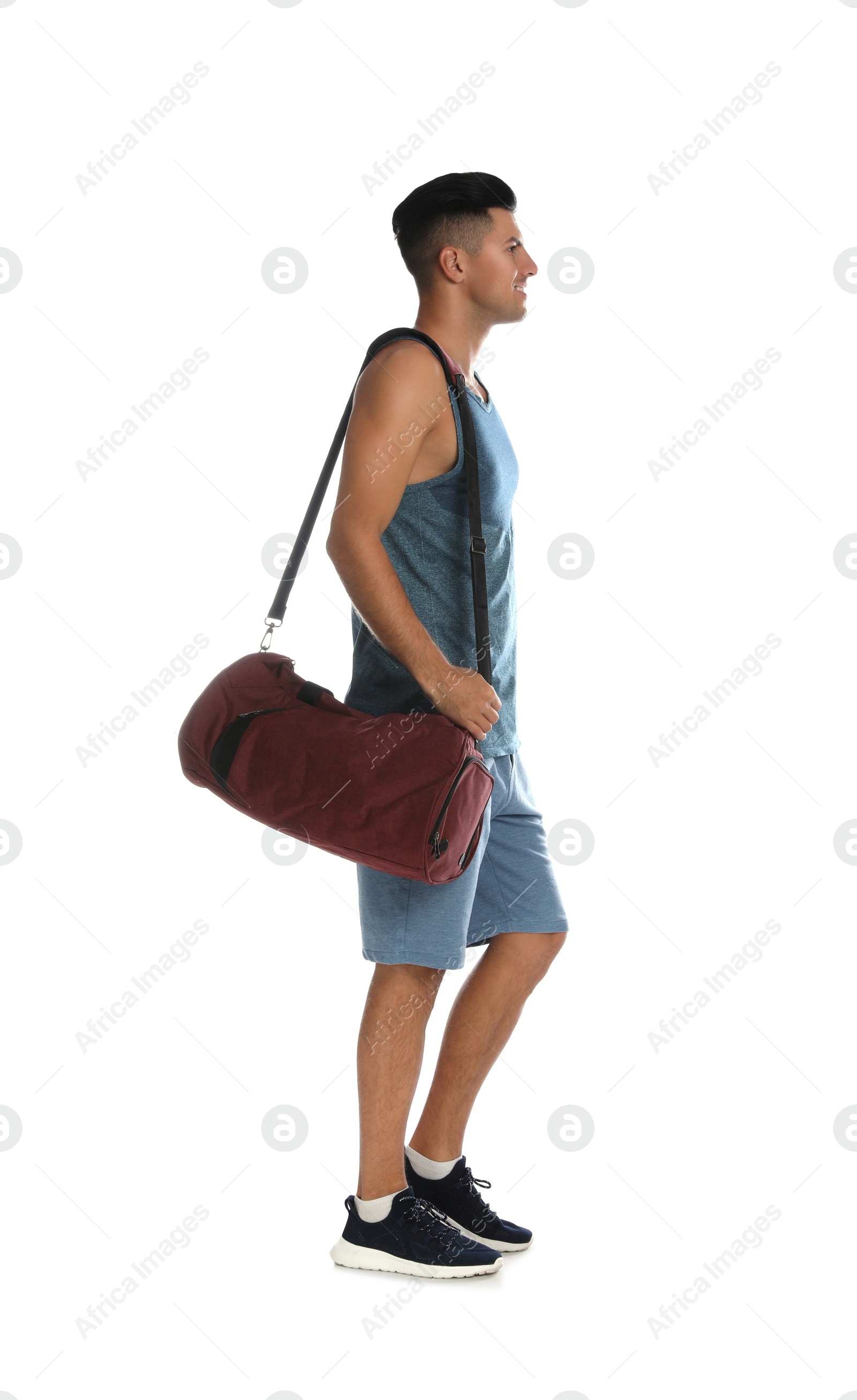 Photo of Handsome man with sports bag on white background