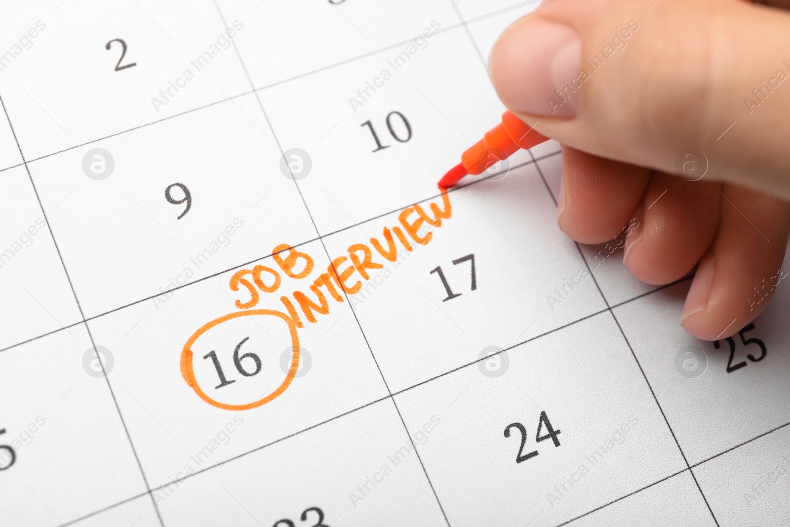 Photo of Woman marking date of job interview in calendar, closeup