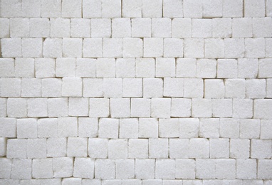 Refined sugar cubes as background, top view