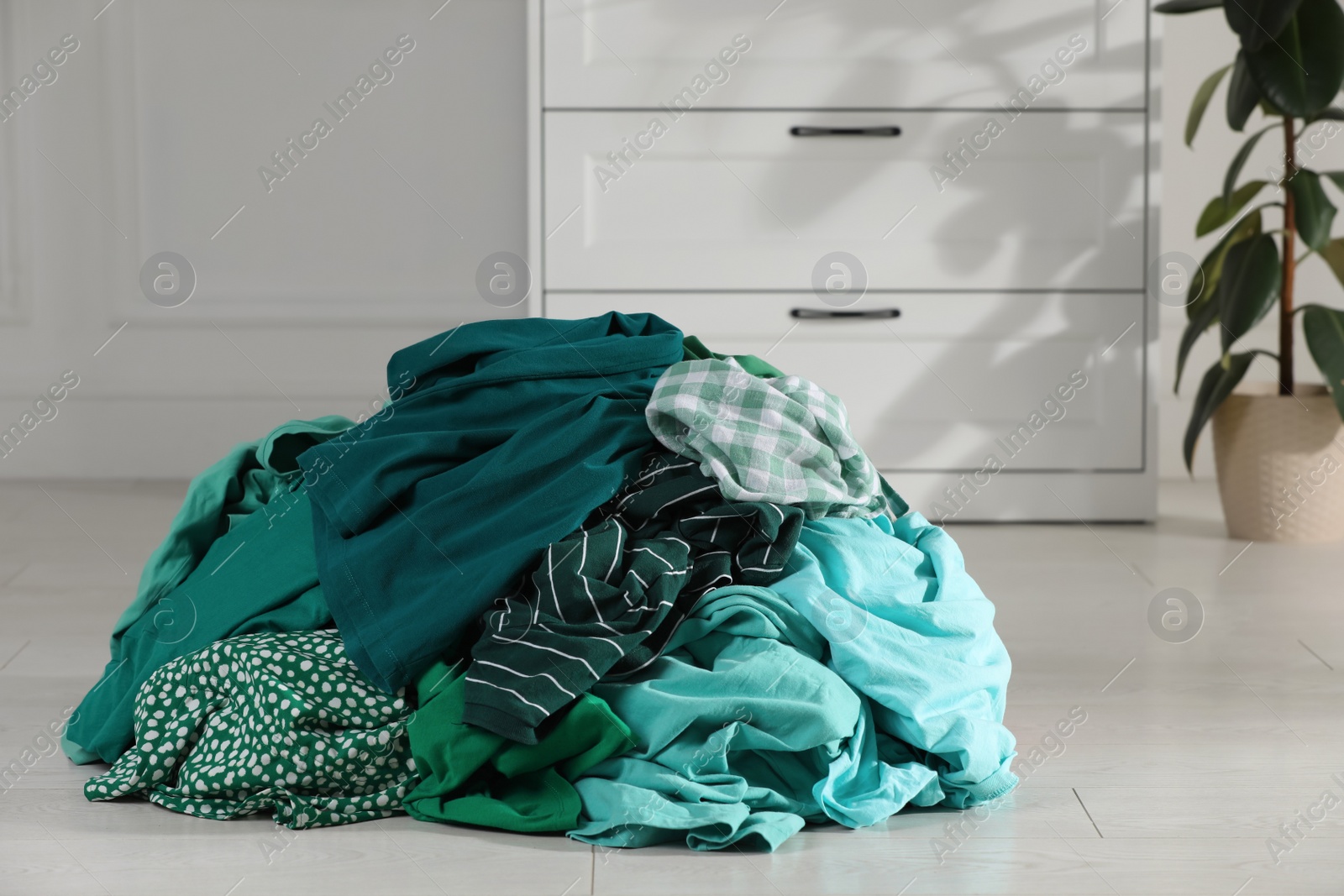 Photo of Pile of dirty clothes on floor indoors