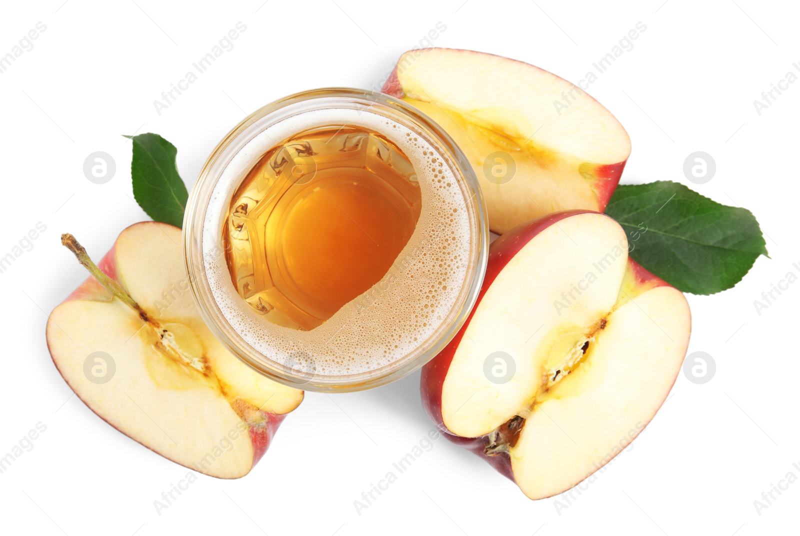 Photo of Delicious cider in glass near pieces of ripe apple on white background, top view