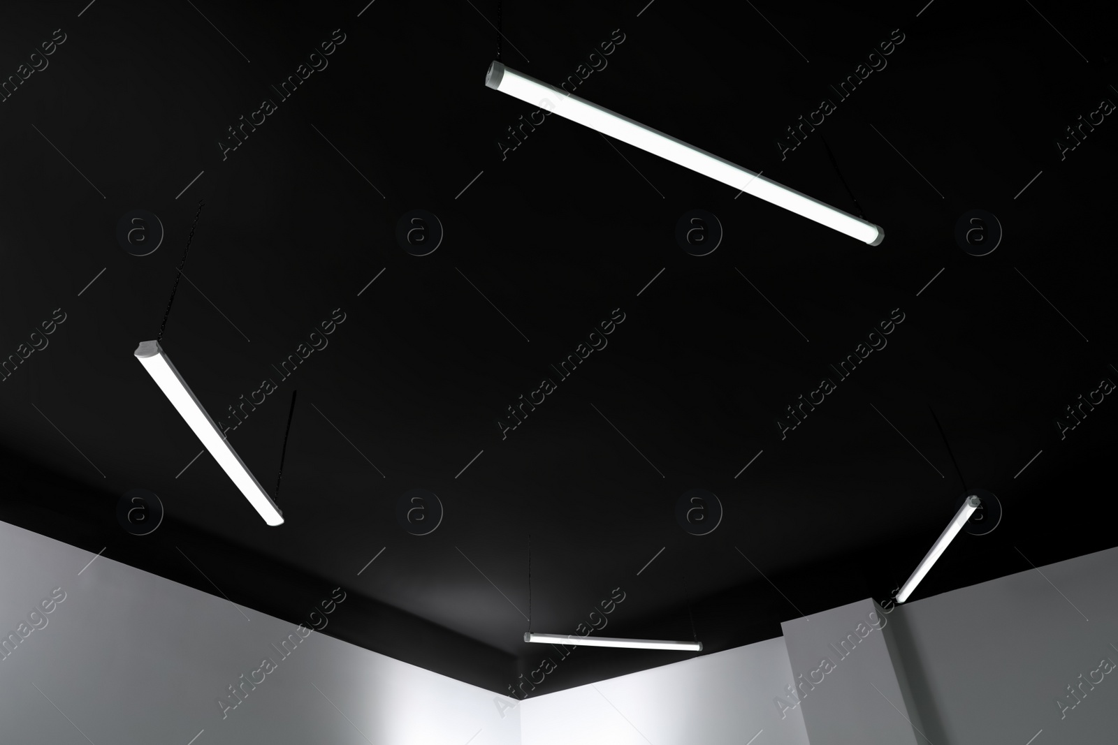 Photo of Black ceiling with lighting in office room