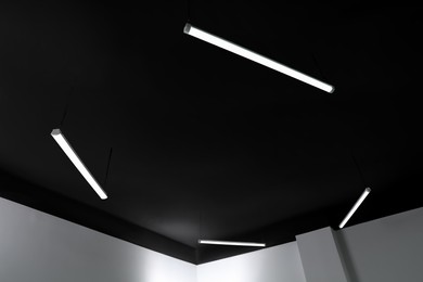 Photo of Black ceiling with lighting in office room