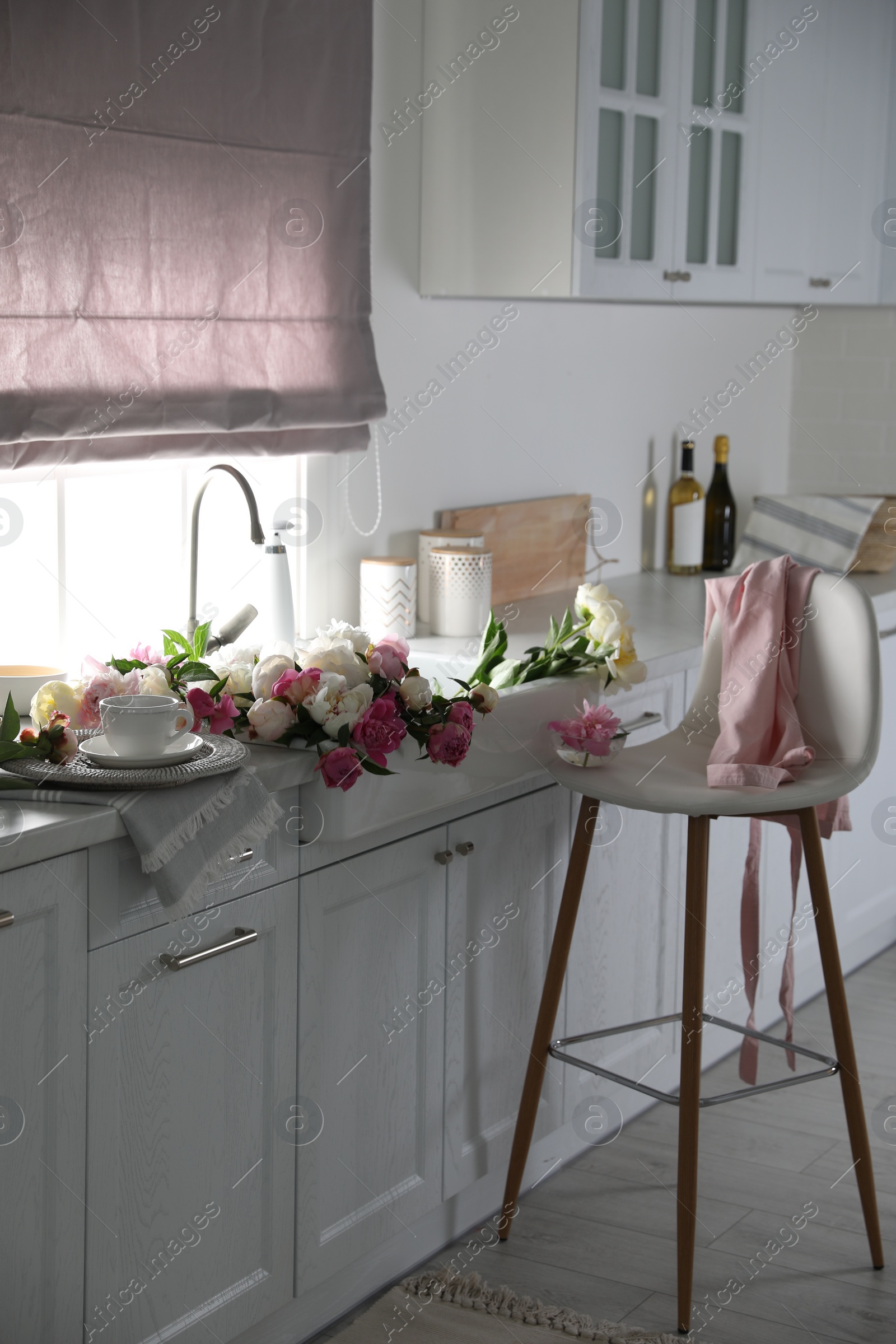 Photo of Bunch of beautiful peonies in kitchen sink