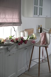 Photo of Bunch of beautiful peonies in kitchen sink