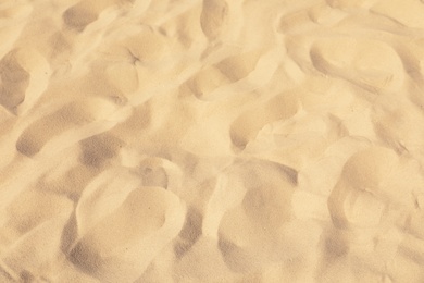 Photo of Golden beach sand on sunny day as background