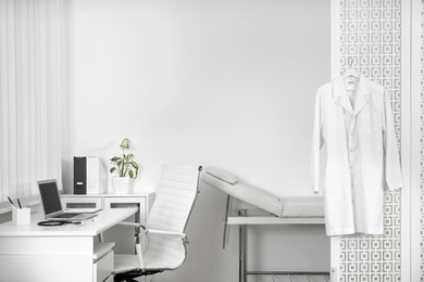 Doctor's office interior with desk and examination couch