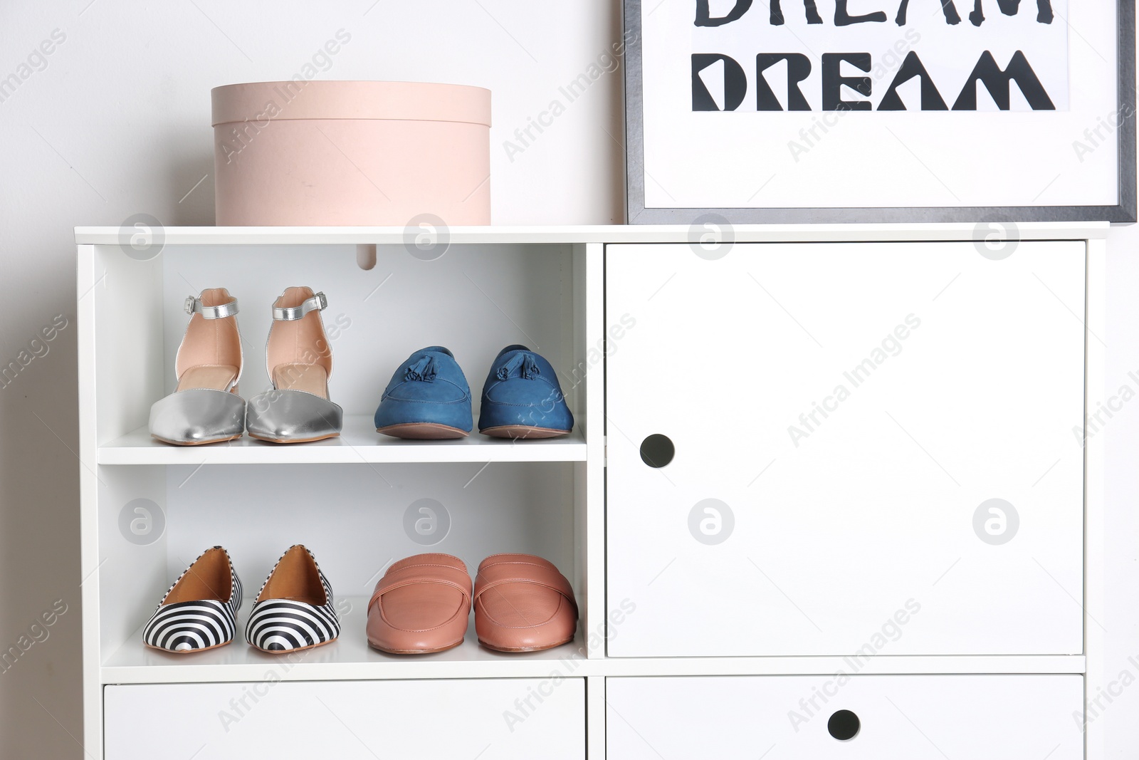 Photo of Different female shoes in storage unit indoors