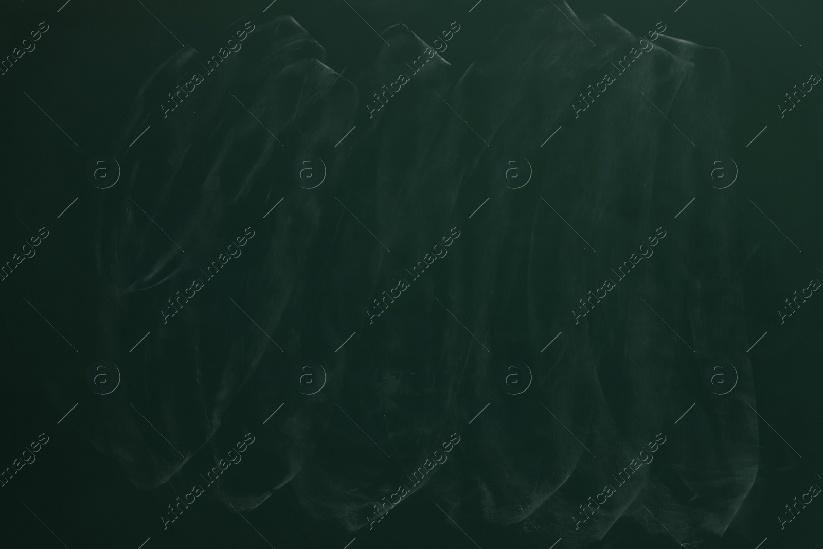 Photo of Chalk rubbed out on green chalkboard as background, closeup. Space for text