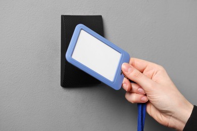 Photo of Woman unlocking door with key card, closeup