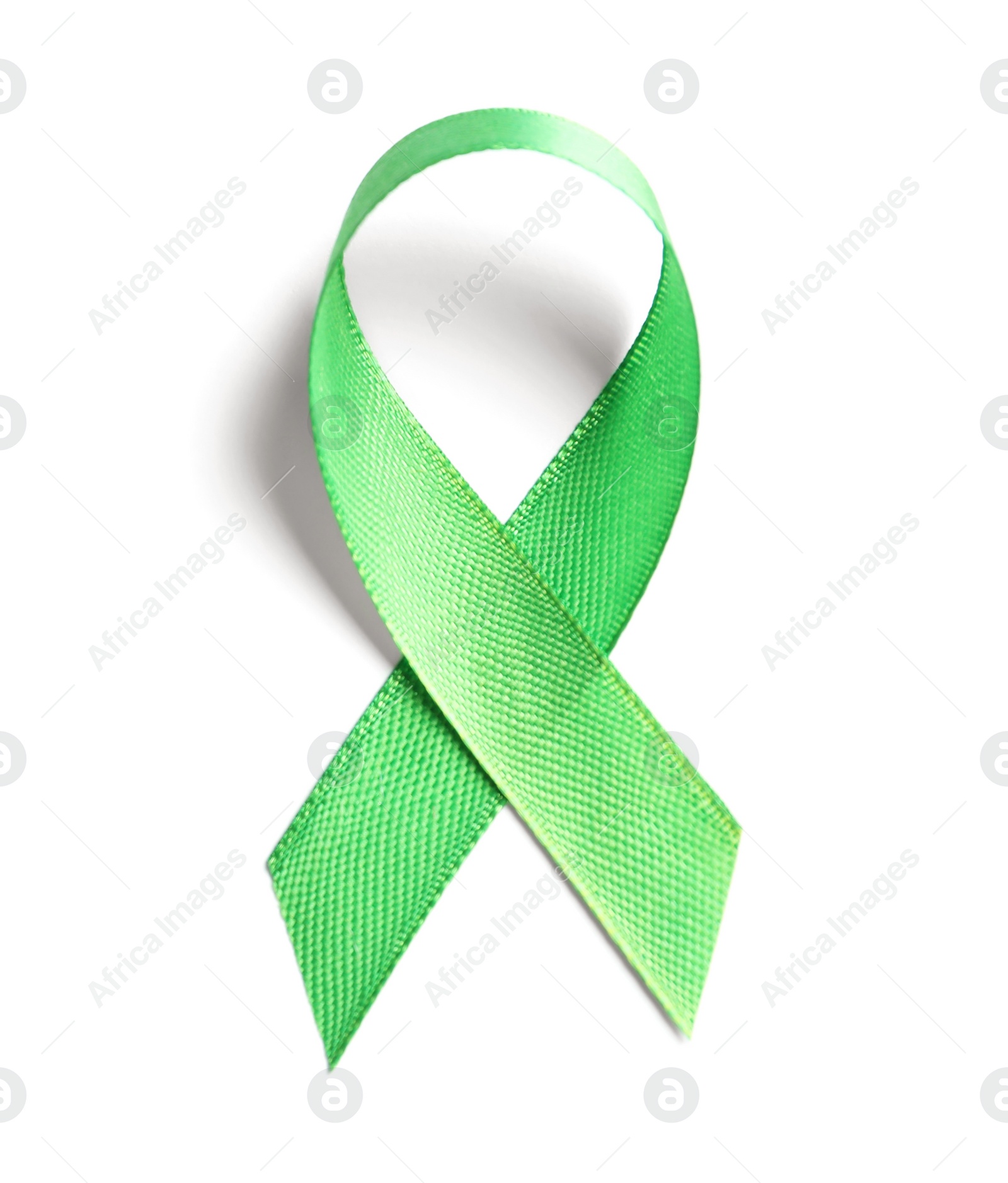 Photo of Green ribbon on white background, top view. Cancer awareness