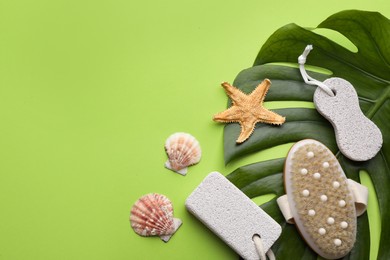 Photo of Flat lay composition with pumice stones on light green background. Space for text