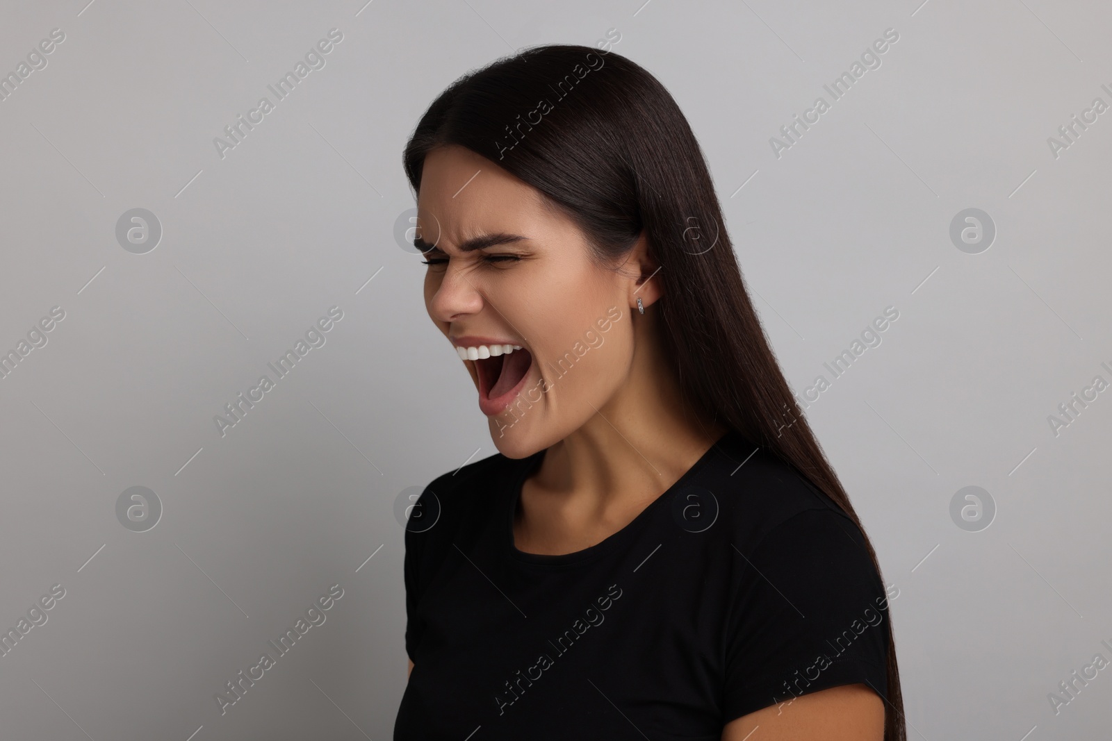 Photo of Personality concept. Emotional woman on grey background