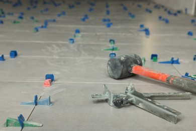 Photo of Beautiful tiles with colorful wedges and professional equipment on floor