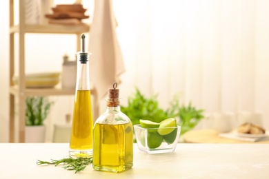 Photo of Composition with fresh rosemary oil on table