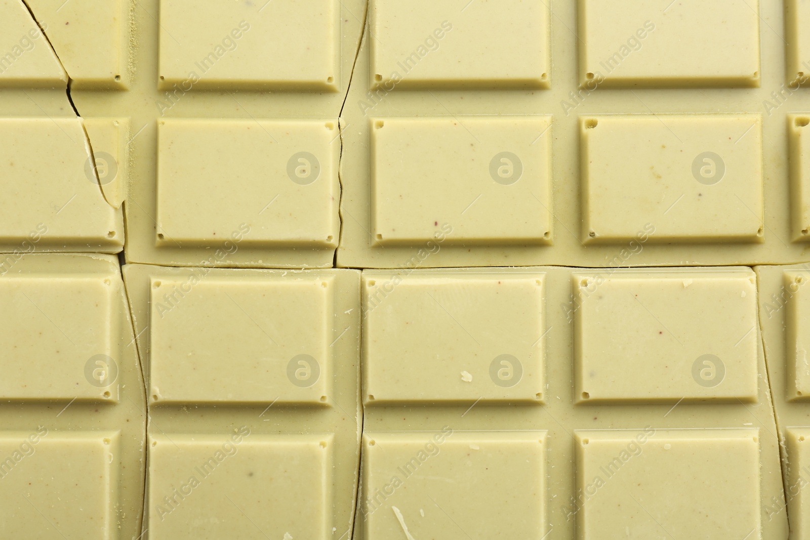 Photo of Broken tasty matcha chocolate bar as background, top view