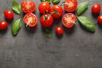 Flat lay composition with ripe cherry tomatoes and basil leaves on color background. Space for text