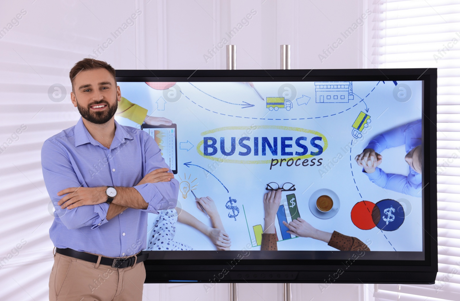 Photo of Business trainer near interactive board in meeting room