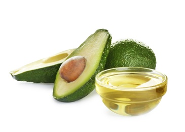 Photo of Bowl of natural oil and avocados isolated on white