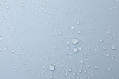 Many water drops on white background, top view