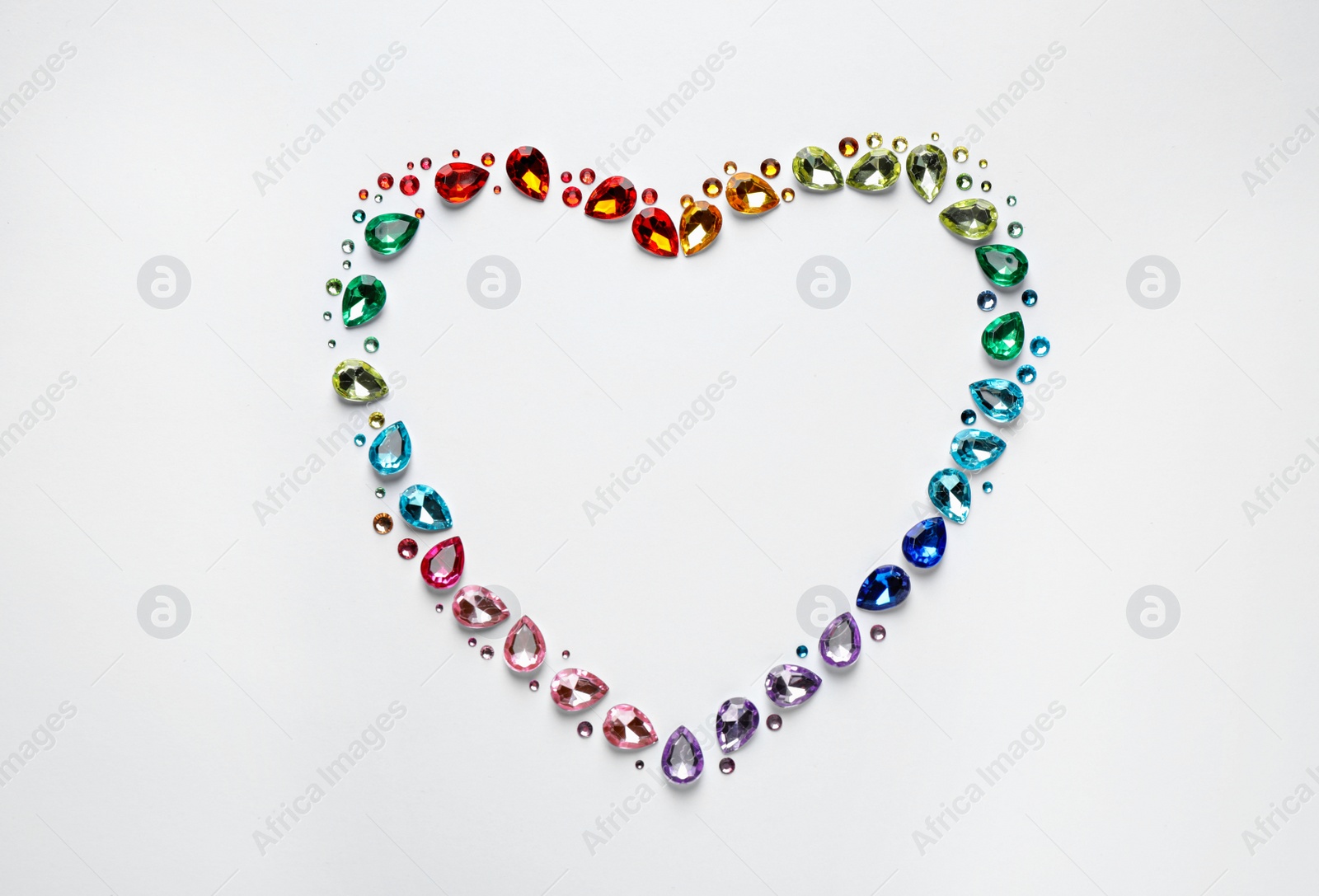 Photo of Frame made of different beautiful gemstones on white background, top view. Space for text