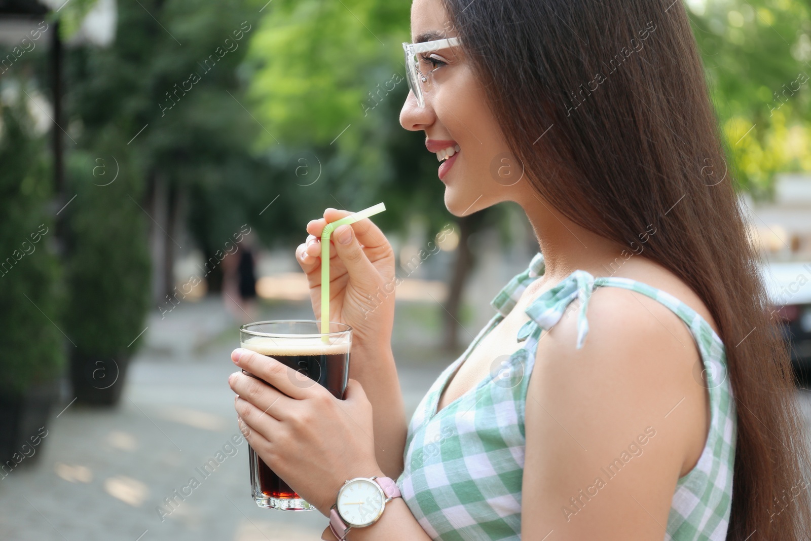 Photo of Young woman with cold kvass outdoors. Traditional Russian summer drink