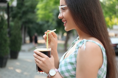 Photo of Young woman with cold kvass outdoors. Traditional Russian summer drink