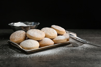 Photo of Tray of traditional cookies for Islamic holidays and strainer on table. Eid Mubarak