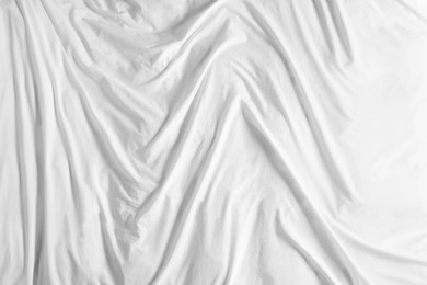 Crumpled white fabric as background, top view