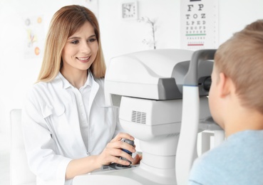 Ophthalmologist examining little boy in clinic