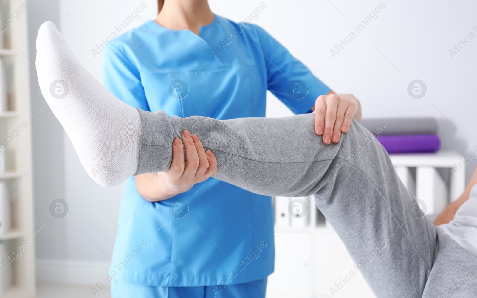 Photo of Doctor working with patient in hospital, closeup. Rehabilitation physiotherapy