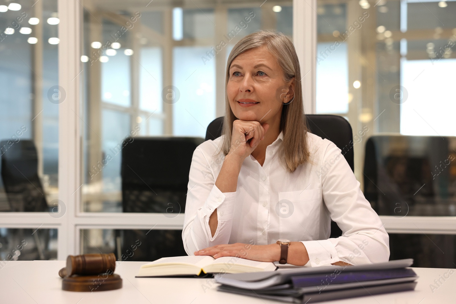 Photo of Portrait of confident lawyer working at table in office