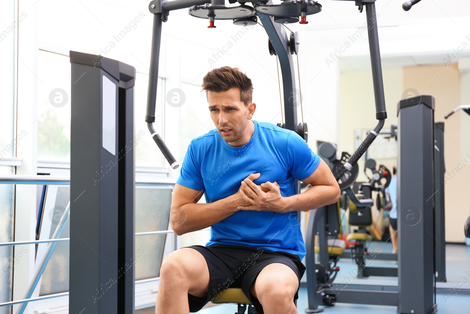 Photo of Young man having heart attack in gym