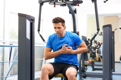 Photo of Young man having heart attack in gym